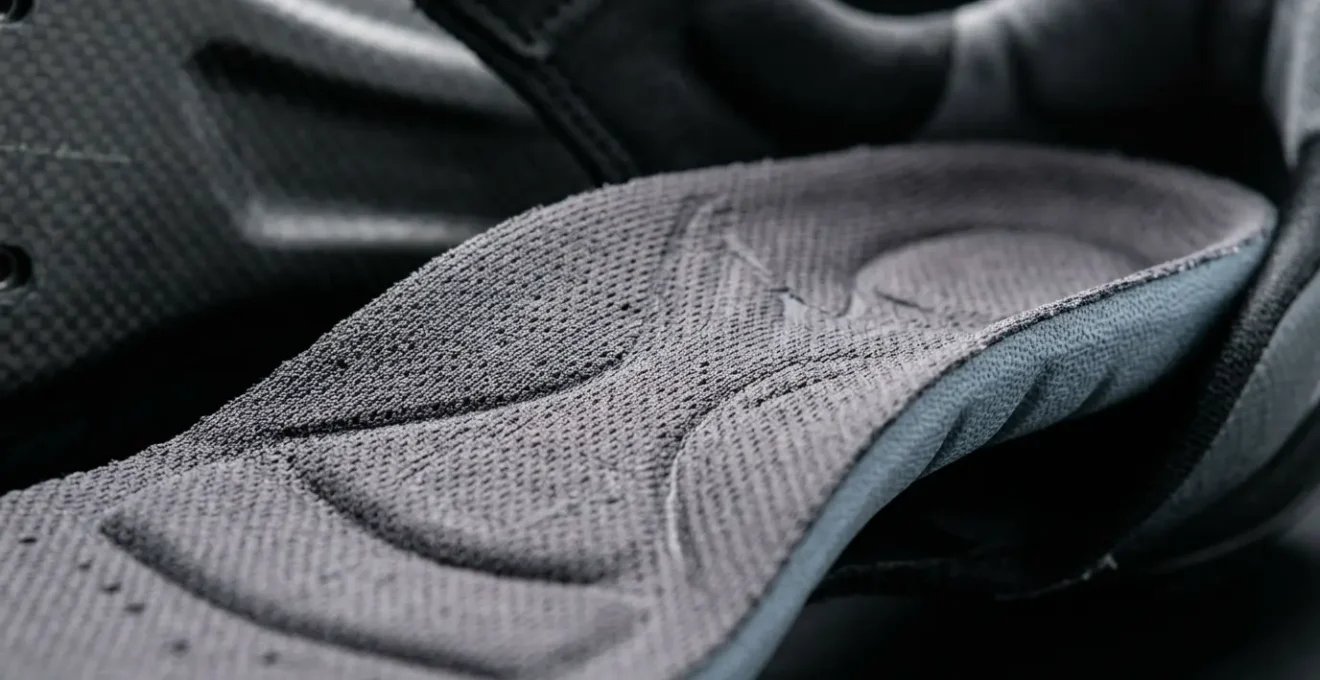 Close-up view of custom arch support cycling insole inside performance shoe highlighting metatarsal support and anatomical contours