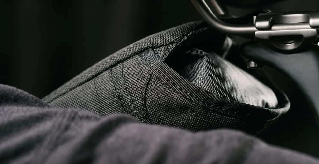 Close-up view showing the tapered profile of a well-designed saddlebag creating clearance between fabric and cyclist's thigh