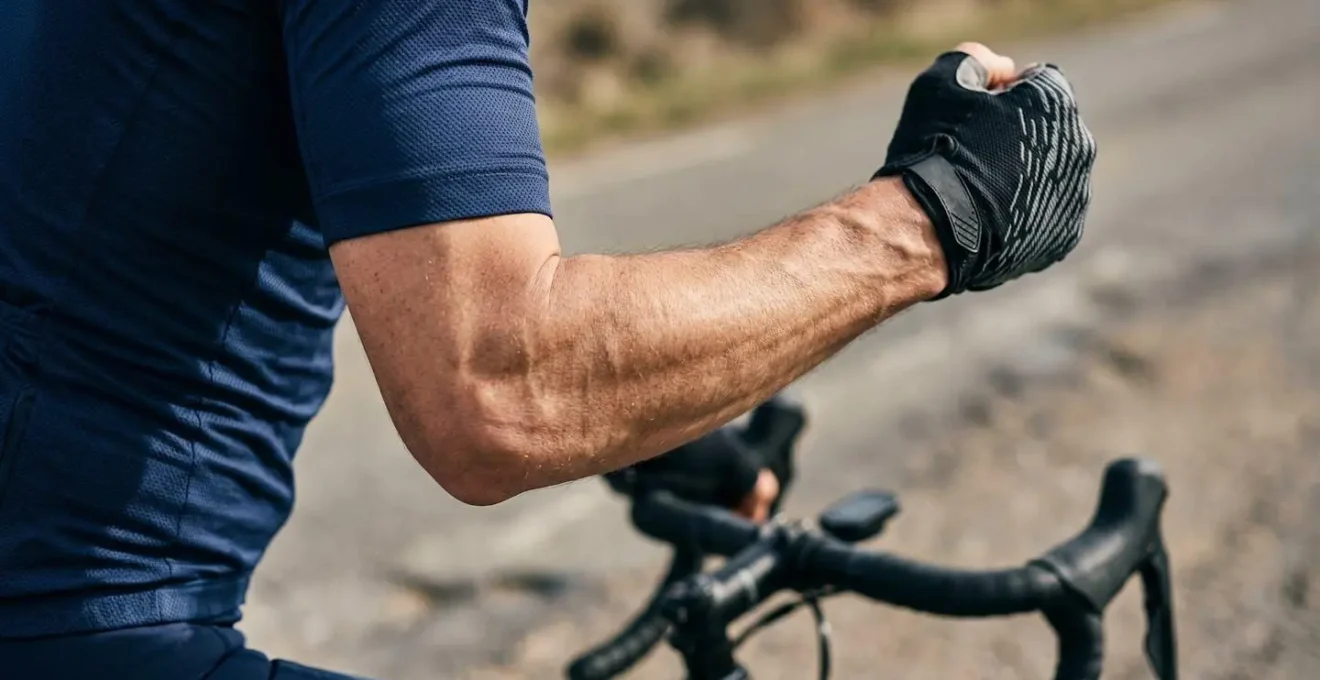 Close-up of cyclist's arm performing the elbow flick signal to indicate pull off