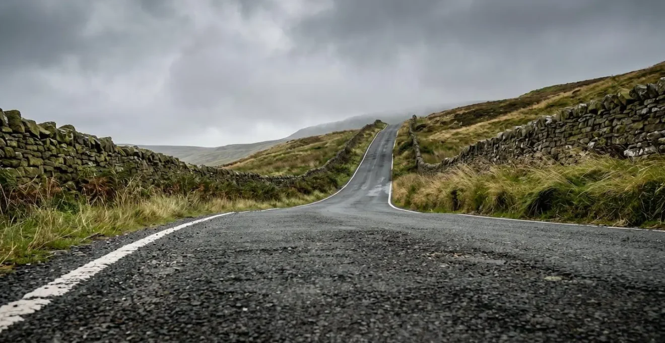 Steep hillside road in the British countryside illustrating the concept of vertical ascent on a short, punchy climb