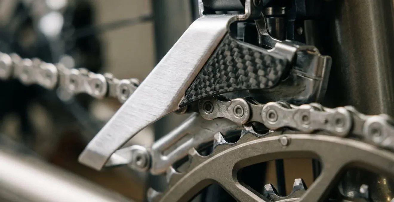 Extreme close-up of electronic front derailleur cage positioning mechanism showing precision alignment during gear transition