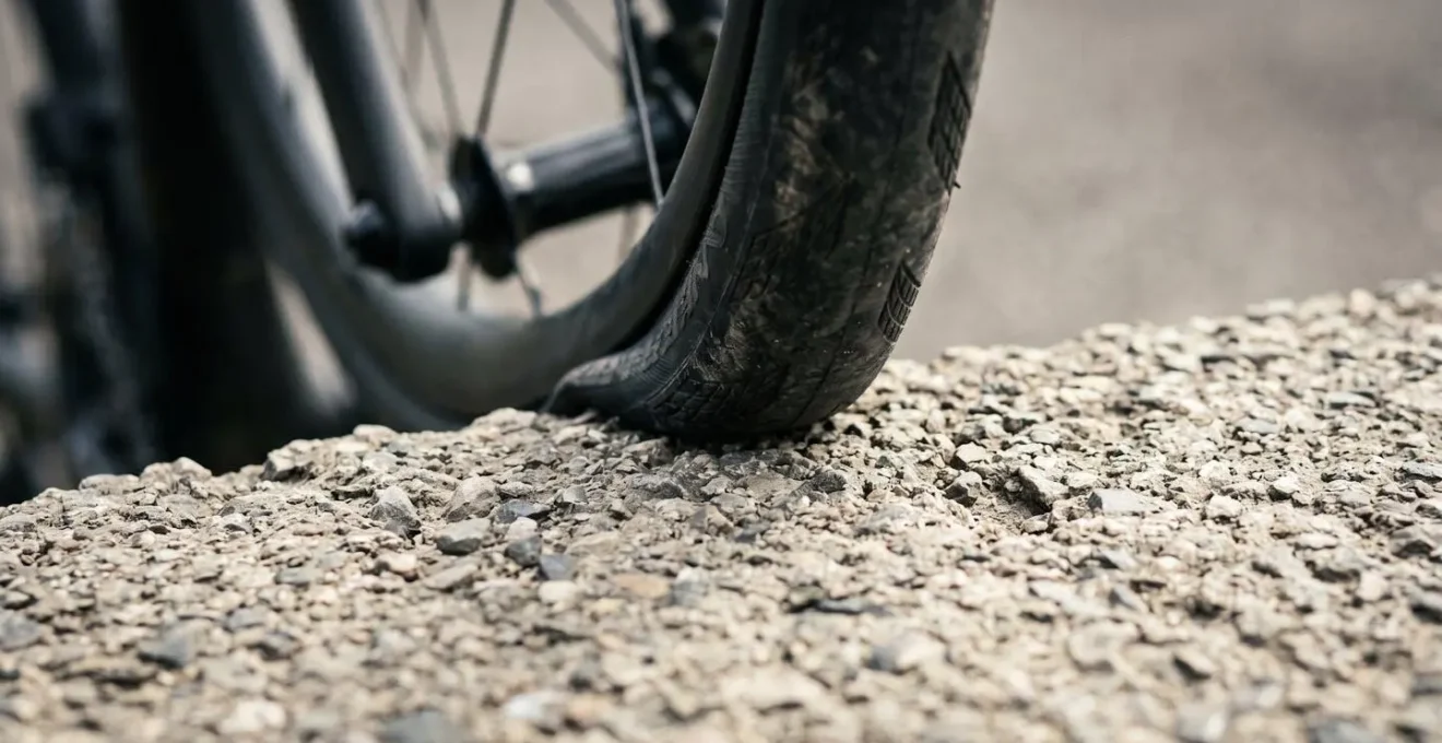Close-up macro detail of bicycle front wheel contact patch demonstrating trail concept