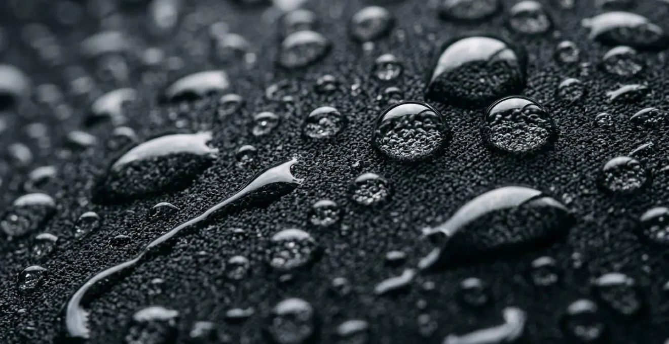 Close-up macro view of water beading on neoprene material surface