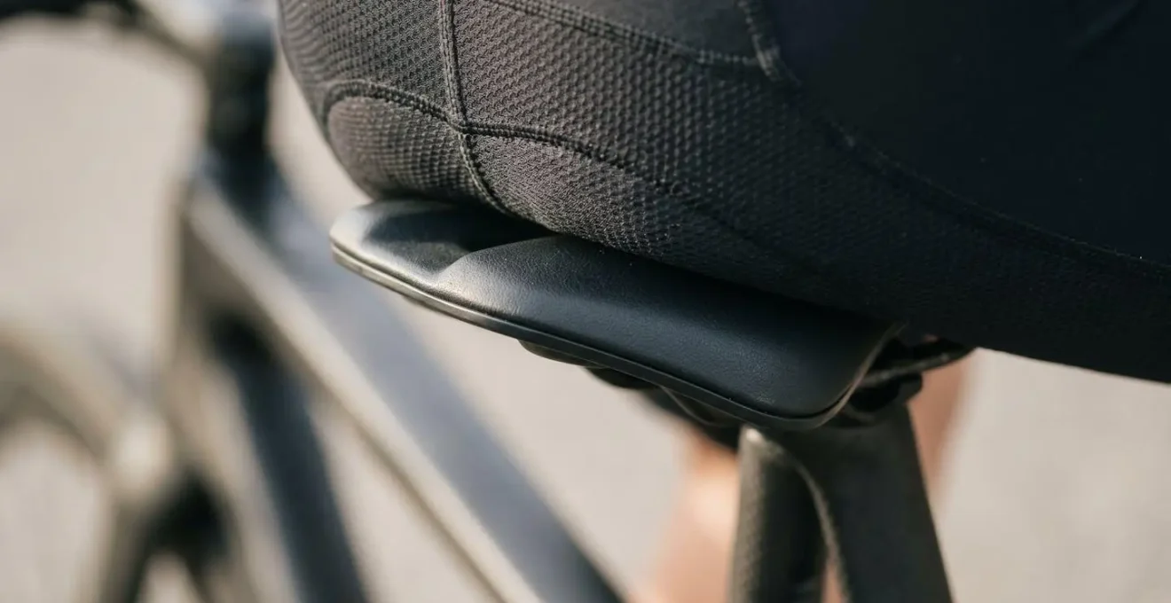 Close-up demonstration of proper bicycle saddle positioning and sit bone support